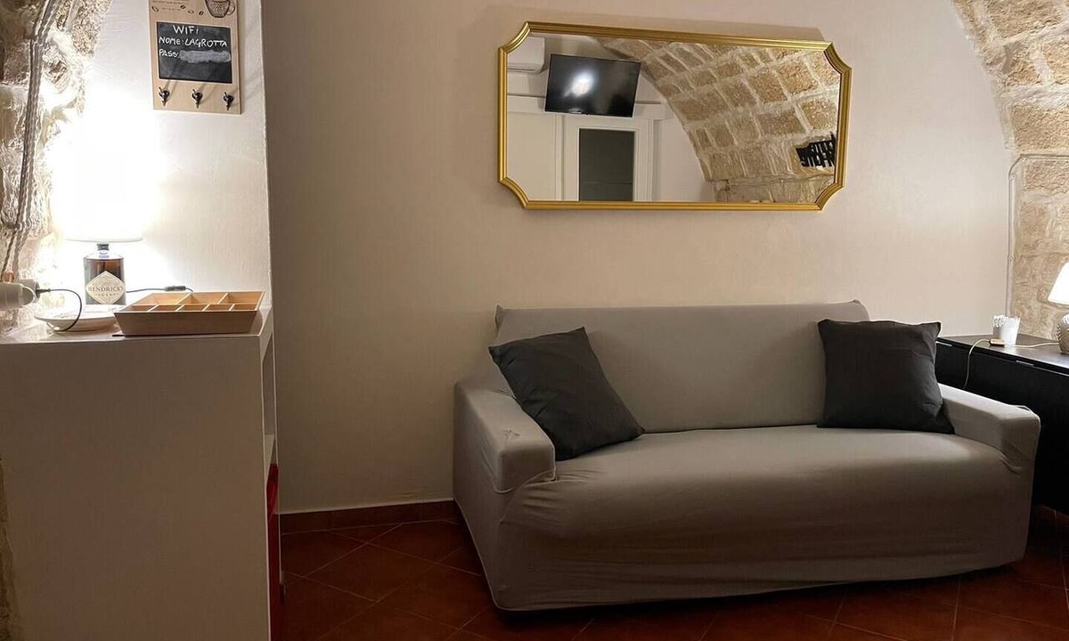 Molfetta House | Grotta Paradiso, a two-story stone cottage with a warm and cozy charm.