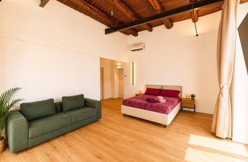 Montecalvario Apartment | Family & Friends Wing at Penthouses Dante. Private wing for groups: 35sqm kitchen/lounge, 3 ensuite bedrooms—30sqm Suite with balcony on Piazza Dante, 20sqm Superior, and a Double room. Access to panoramic rooftop over historic center's ancient domes.