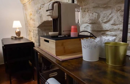 Molfetta House | Grotta Paradiso, a two-story stone cottage with a warm and cozy charm.
