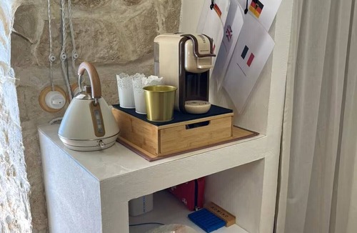 Molfetta House | Grotta Paradiso, a two-story stone cottage with a warm and cozy charm.