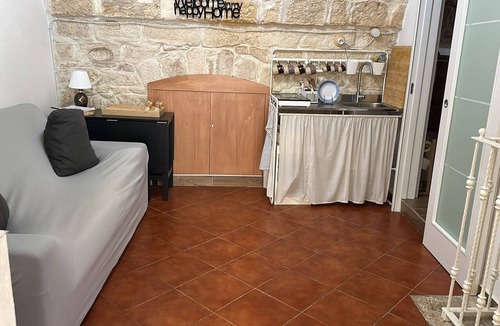 Molfetta House | Grotta Paradiso, a two-story stone cottage with a warm and cozy charm.