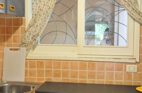 Baia Caddinas Apartment | In a villa with garden overlooking the sea, an apartment with sunny terrace.