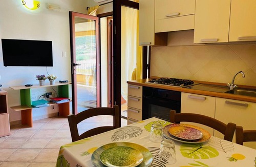 Limpiddu Apartment | New Orange Studio Apartment in Limpiddu, Budoni – Pool, Terrace, Wi-Fi
